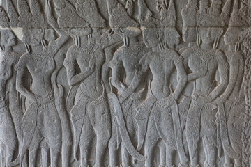 Stone bas-relief with human figures in Angkor Wat temple, Siem Reap, Cambodia. Male figure stone carving on ancient wall