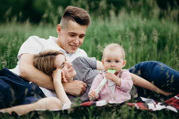 Naklejka na ściany i meble Couple with baby daughter enjoy time together