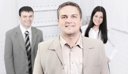 confident young businessman on background of office