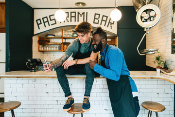Portrait of the young owners of a cool pastrami bar taking a selfie.