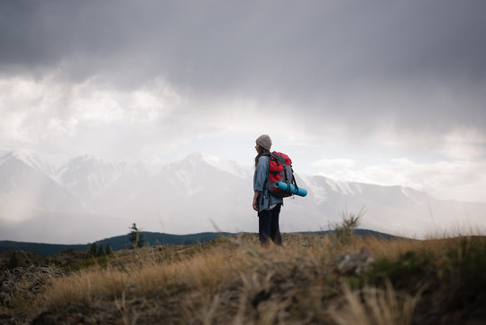 Girl with backpack on nature