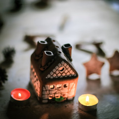gingerbread house candle on blurred background of the table.