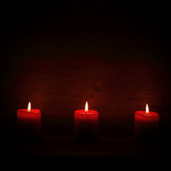 three candles on an abstract festive background
