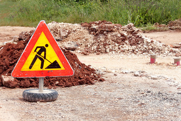 Road works sign for construction works, road, pavement construction. Traffic, warning sign road repairing, road maintenance. Red, black, yellow triangle road sign work. Reconstruction, infrastructure.