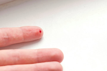 Cut on the finger of a man's hand. Blood flows.