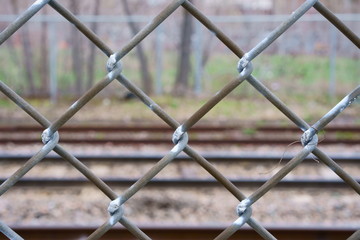 A fence along a railway track.