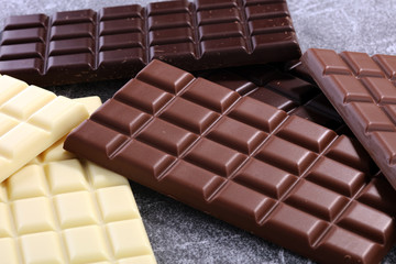 chocolate in different color. milk, dark and white chocolate bars