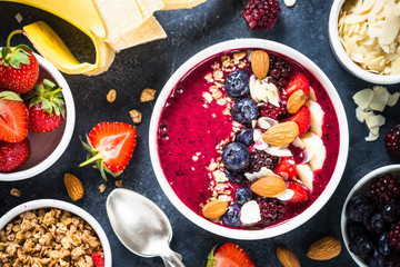 Smoothie bowl from fresh berries, nuts and granola.