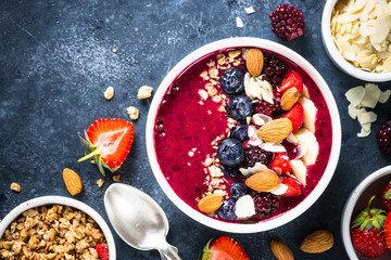 Smoothie bowl from fresh berries, nuts and granola.