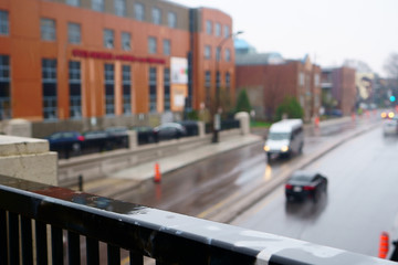 In a rainy day, out of focus traffic into this occidental city.