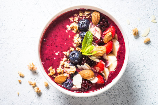 Smoothie bowl from fresh berries, nuts and granola.