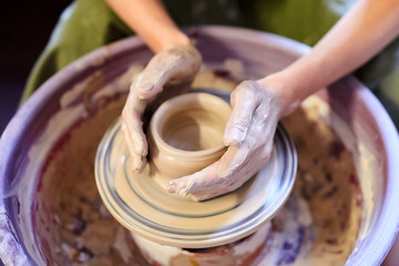 Pottery wheel. Occupation of art therapy. Making a pot of clay. Female hands