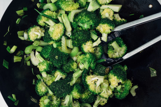 Fresh broccoli stir fry in a wok