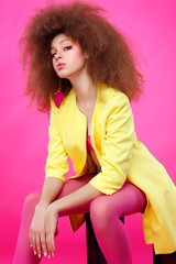 A photo of beautiful girl is in fashion style on  pink  background, glamour