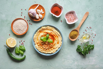 Hummus on the table and ingredients for traditional hummus.