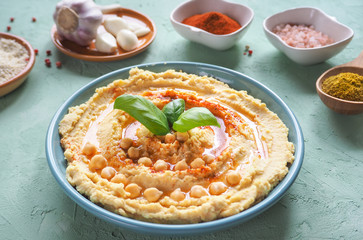 Hummus on the table and ingredients for traditional hummus.