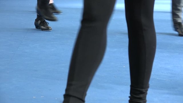 Close up of black tap shoes, shiny light, tappers live on blue carpet. Man and women&nbsp;dancing together tap dance at 50s jazz music party. Vintage style, leisure and musical and artistic culture