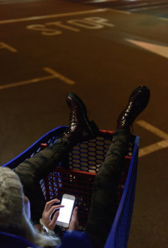 Woman using phone in trolley