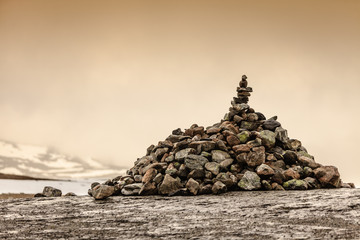 Stone stack and snowy mountains Norway