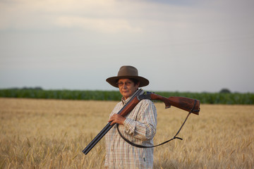 woman hunter in the field of grain