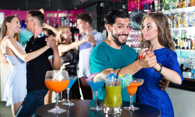 Female with man are dancing in bar