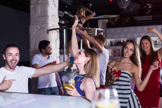 Group of young people clubbing in the club