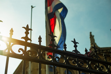 The flag of Costa Rica waving against the sun at the heart of San José