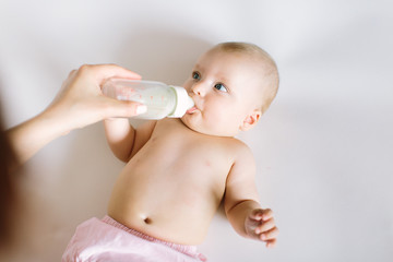 Feeding Baby. Baby eating milk from the bottle.