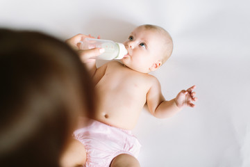 Feeding Baby. Baby eating milk from the bottle.