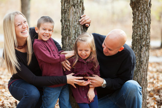 Autumn: Family Having Fun Trying To Get Girl To Smile