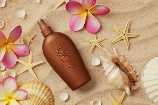 suntan lotion and seashells on sand beach