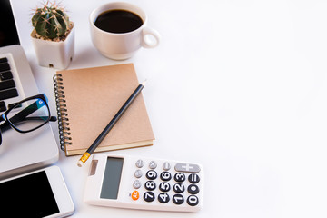 White office desk table, workspace office with laptop, smartphone black screen, pen, calculator, glasses, Top view with copy space