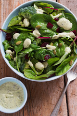 Superfood salad bowl. Mixed leaf salad with beetroot & pumpkin with creamy avocado dressing.