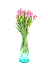 A bouquet of pink tulips in a glass vase is isolated on a white background.