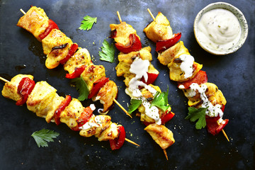 Chicken skewer kebab with bell pepper and yogurt sauce.Top view with copy space.