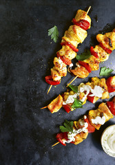 Chicken skewer kebab with bell pepper and yogurt sauce.Top view with copy space.
