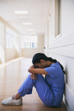 Hospital: Frustrated Nurse Sits In Hallway Alone