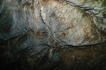 Beautiful cave. View from inside dark dungeon. Textured walls of cave. Background image of underground. Dampness inside cave.