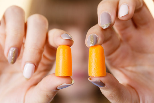 Woman Holding Protective Earplugs