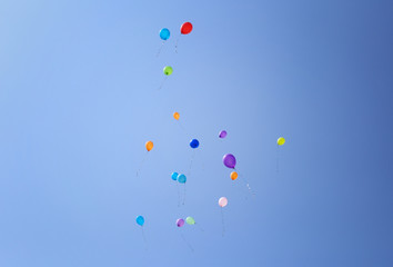 Colorful balloons on a blue sky background