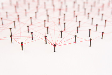 Linking entities, social media, Communications Network, The connection between the two networks. Network simulation on white paper linked together with a red thread with copy space