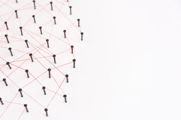 Linking entities, social media, Communications Network, The connection between the two networks. Network simulation on white paper linked together with a red thread with copy space