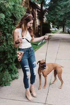A young woman walking her dog
