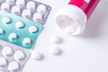 Pills from bottle on the white background