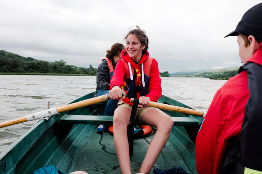 teens and kids on rowboat