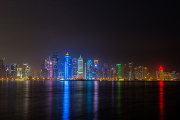 Fototapeta na wymiar doha night city reflecting in water of persian gulf