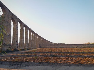 Beautiful ancient monument, a stone aqueduct that served to convey water with the background a blue sky