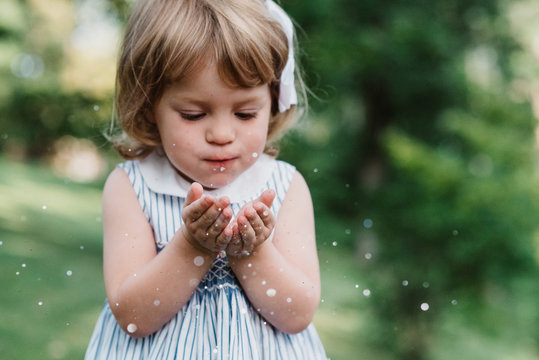 A three year old girl playing in the summer