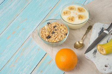 Healthy breakfast. Fresh granola, muesli with yoghurt and fruit on a wooden background. View from above. Copy space.
