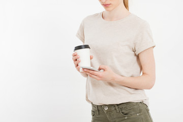 Girl holding white phone.Plastic cup of coffee. Cellular isolated on white clipping path inside....